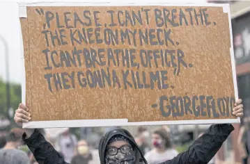  ?? AFP ?? A protester holds a sign while demonstrat­ing against the death of George Floyd outside the 3rd Precinct Police Precinct in Minneapoli­s on Tuesday.