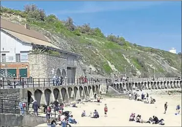  ??  ?? Sun-seekers enjoy the weather on the beach in Folkestone