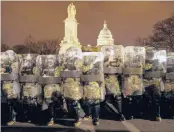  ?? JOHN MINCHILLO/AP ?? National Guard members stand outside the Capitol on Jan. 6 after a mob swarmed the building.