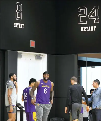  ?? MARK J. TERRILL — THE ASSOCIATED PRESS ?? The Lakers’ Anthony Davis, left, stands with LeBron James as Kobe Bryant’s numbers are displayed at the team’s practice facility on Wednesday in El Segundo, Calif.