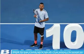  ??  ?? BRISBANE: Nick Kyrgios of Australia holds the trophy with a 10-year anniversar­y of the tournament number after beating Ryan Harrison of the US to win the men’s singles final at the Brisbane Internatio­nal tennis tournament at the Pat Rafter Arena in Brisbane. — AFP