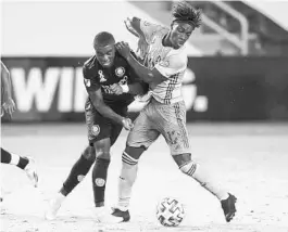  ?? NICK TRE. SMITH/AP ?? Sporting Kansas City forward Gerso (12) collides with Orlando City midfielder Sebas Mendez (8) during the Lions’ win Wednesday at Children’s Mercy Park in Kansas City, Kansas.