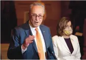  ?? CAROLYN KASTER/ASSOCIATED PRESS ?? Senate Majority Leader Chuck Schumer of New York speaks to reporters in August as House Speaker Nancy Pelosi of California listens.