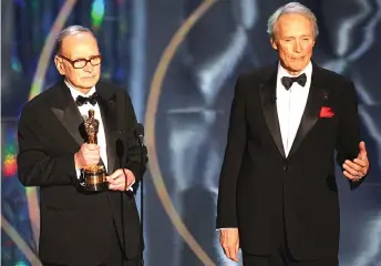  ?? — AFP file 1photo ?? Actor and film director Clint Eastwood translates the acceptance speech from Morricone, receiver of the Honourary Award, at the 79th Academy Awards in Hollywood.