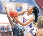  ?? [PHOTO BY BRYAN TERRY, THE OKLAHOMAN] ?? Moore’s Aaliyah Moore moves past Edmond Santa Fe’s Keira Neal during Tuesday’s high school basketball game in Moore.