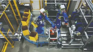  ??  ?? Robotic assembly in action at Promation’s Oakville facility.