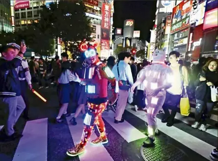  ?? — The Japan Times ?? The costumes in Japan are so technologi­cally advanced, they light up!