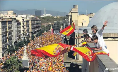  ??  ?? People wave Spanish flags in a protest in Barcelona against Catalan independen­ce moves.