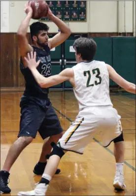  ?? MIKE BUSH/NEWS-SENTINEL ?? Above: Liberty Ranch center Chris Fielding looks to pass the ball in front of Placer center Noah Richardson in the first quarter of Saturday CIF boys basketball game. Below: Liberty Ranch guard Chandler Garcia soars into the air for a basket.