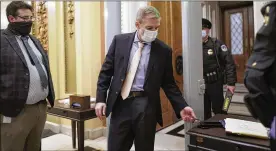  ?? J. SCOTT APPLEWHITE/AP ?? Rep. Jim Jordan, R-Ohio, an ally of President Donald Trump, passes through a metal detector as he enters the House chamber Tuesday. New security measures put into place after a mob loyal to Trump stormed the Capitol last week.