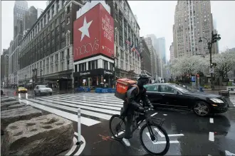  ?? MARK LENNIHAN — THE ASSOCIATED PRESS ?? Traffic is light Monday outside Macy’s in Herald Square in New York. Macy’s stores nationwide are closed due to the coronaviru­s.