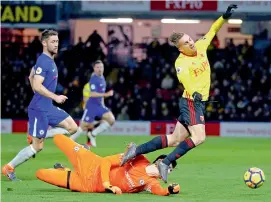  ?? — AP ?? Chelsea goalkeeper Thibaut Courtois (left) fouls Gerard Deulofeu of Watford to concede a penalty in their English Premier League match at the Vicarage Road Stadium in London on Monday. Watford won 4-1.