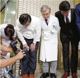  ??  ?? YOKOHAMA: In this Sept. 24, 2016 photo, Oguchi Hospital chief Yoichi Takahashi, third left, and hospital staff bow as they speak to media in front of the hospital. — AP