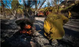  ?? Photograph: Apu Gomes/AFP via Getty Images ?? A firefighte­r controls a hotspot in Santa Paula, Ventura county, California.