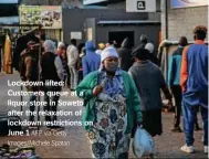  ?? AFP via Getty Images/Michele Spatari ?? Lockdown lifted: Customers queue at a liquor store in Soweto after the relaxation of lockdown restrictio­ns on June 1