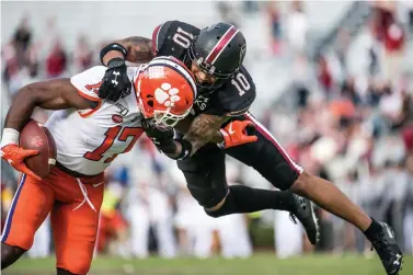  ?? AP Photo/Sean Rayford ?? ■ South Carolina defensive back R.J. Roderick (10) tackles Clemson wide receiver Cornell Powell (17) during the second half of an NCAA football game Saturday in Columbia, S.C. Clemson defeated South Carolina, 38-3.
