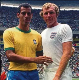  ?? — AP ?? Brazil captain Carlos Alberto, left, and England captain Bobby Moore, pose for a photo prior to their World Cup 1970 match in Guadalajar­a, Mexico. The bright yellow 1970 Brazil jersey has gone one to attain iconic status.