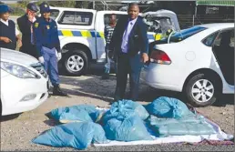  ?? PICTURE: SUPPLIED ?? DIRTY ROADS: Community Safety MEC Dan Plato and traffic officials bust a motorist transporti­ng millions of rands worth of compressed dagga into the province during a roadblock.