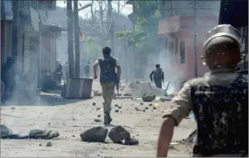  ??  ?? Indian security personnel and protesters clash following a gunbattle between security forces and suspected rebels in Srinagar.— AFP photo