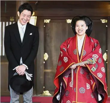  ?? — Reuters ?? Charming couple:Ayako with Moriya speaking to reporters after their wedding ceremony at the Meiji Shrine in Tokyo.