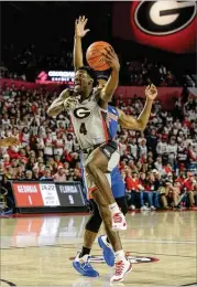  ?? RICH VON BIBERSTEIN / ICON SPORTSWIRE ?? Georgia guard Tyree Crump, who had six points, drives to the basket against Florida at Stegeman Coliseumon Saturday.