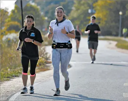  ?? ABEL URIBE/CHICAGO TRIBUNE ?? Kaitlyn Simoneau gives a thumbs-up as she nears Mile 19 south of McCormick Place while running the virtual Chicago Marathon on Saturday.
