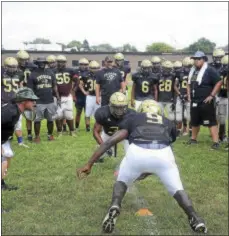  ?? GREGG SLABODA — TRENTONIAN PHOTO ?? Truman head football coach Jon Craig, left, watches his team at practice.