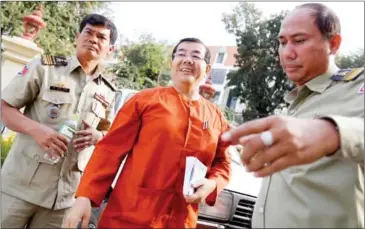  ?? PHA LINA ?? Former Phnom Penh municipal police chief Heng Pov, is escorted by authoritie­s to the Supreme Court for a hearing last week in Phnom Penh.