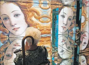  ?? ASSOCIATED PRESS ?? In this Friday, June 5, 2015 file photo a person visits the Italian pavilion as Sandro Botticelli’s mid 1480s painting of Birth of Venus is displayed on the walls at the Expo 2015 in Rho, near Milan, Italy. A new exhibition of Italian Renaissanc­e...