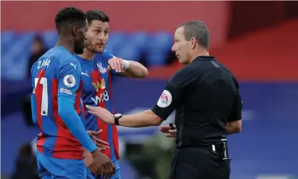  ??  ?? Referee Kevin Friend explains his decision after awarding a penalty for Joel Ward’s handball. Photograph: Tom Jenkins/the Guardian