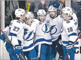  ?? Patrick Smith Getty Images ?? LEFT WING ALEX KILLORN, second from right, celebrates with Tampa Bay teammates after his third-period goal gave the Lightning a 3-2 lead.