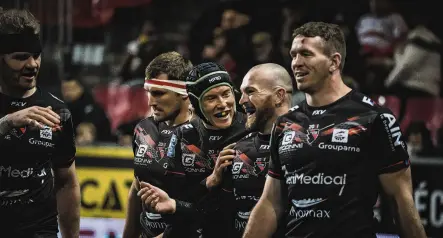  ?? ?? If only . . . Stark (second right) is congratula­ted by his Oyonnax teammates after scoring a try. It was then disallowed — ironically, because Ensor was ruled to have delivered a forward pass.