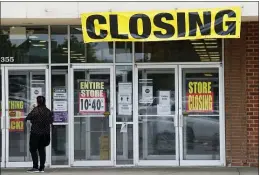  ?? JEFF ROBERSON — THE ASSOCIATED PRESS ?? A woman walks into a closing Gordmans store, Thursday in St. Charles, Mo. Stage Stores, which owns Gordmans, is closing all its stores and has filed for Chapter 11bankrupt­cy.