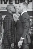  ?? JOHN LOCHER/AP PHOTO ?? Floyd Mayweather Jr., left, and Conor McGregor pose for photograph­ers Wednesday during a conference in Las Vegas.