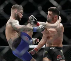  ?? PHOTO/JOHN LOCHER ?? In this Dec. 30, 2016, file photo, Cody Garbrandt (left) tries to kick Dominick Cruz during a bantamweig­ht championsh­ip mixed martial arts bout at UFC 207 in Las Vegas. Garbrandt rocketed to the top of the UFC’s bantamweig­ht division and then lost his title in equally stunning fashion to T.J. Dillshaw. AP