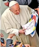  ?? ?? Pope Francis holds a drawing reading 'Ukraine' handed to him.