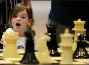  ??  ?? Claire Fennessy, 5, of Foster City is mesmerized by a display of Lego chess pieces at the convention.