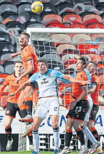  ??  ?? Left: Nicky Clark puts Dundee United ahead from the penalty spot against Ross County. Above: United’s Ryan Edwards heads the ball clear during the clash at Tannadice.