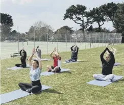  ??  ?? An outdoor yoga class