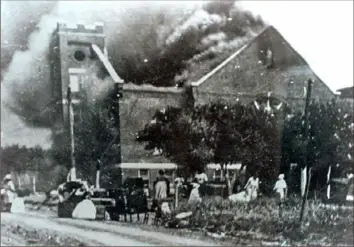  ?? Tulsa World/Greenwood Cultural Center via AP ?? Mt. Zion Baptist Church burns after being torched by white mobs during the 1921 Tulsa race riot. President Donald Trump plans for a rally on Juneteenth -— the celebratio­n of the end of slavery in the U.S. — in Tulsa has caused backlash from black community and political leaders.