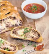  ?? MELEYNA NOMURA/THEKITCHN.COM ?? This hearty, homemade bread is made with ground sausage rolled in pizza dough.