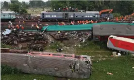  ?? Photograph: Punit Paranjpe/AFP/Getty Images ?? A packed passenger train collided with a goods train after mistakenly being diverted.