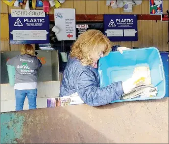  ?? Lynn Atkins/The Weekly Vista ?? Libby Bailey empties a bin of paper at the Bella Vista Recycling Center. The center is open 24 hours a day, and during most weekdays volunteers are available to help unload and sort.