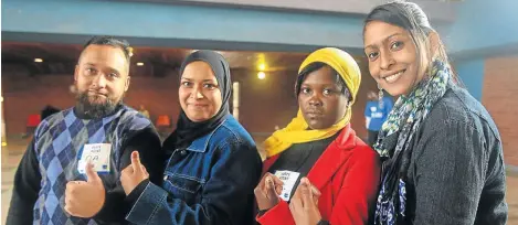  ?? Picture: KATHERINE MUICK-MERE ?? PROUDLY DEMOCRATIC: Zane and Farieda Joosub, Sheila Matsaung and Whafieka Joosub show off their inked thumbs at the Laudium Civic Centre