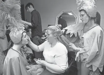  ?? THE COMMERCIAL APPEAL FILES ?? Leerin Campbell, left, has her makeup done Feb. 23, 2010, by Maggie Baker, who in turn has her hair done by Kayla Smith. Campbell and Smith were “bird girls” and Baker played Gertrude Mcfuzz, in Hernando High’s production of “Seussical the Musical.”