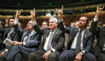  ?? PHOTOS BY JAY JANNER / AMERICAN-STATESMAN ?? Some of those who put up their horns in honor of Augie Garrido included (from left) Garrido’s nephew Michael Clark, DeLoss Dodds, Mack Brown and Huston Street.