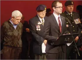  ?? GUARDIAN PHOTO BY MITCH MACDONALD ?? Ryan Gallant speaks about working as a guide at the Canadian National Vimy Memorial during the Tribute to Veterans hosted by the City of Charlottet­own at the Confederat­ion Centre of the Arts’ Homburg Theatre on Sunday. Next to Gallant are, from left,...