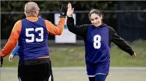  ?? James Franco / Special to the Times Union ?? Anna Santiago gives a high five to Kevin Musco during the unified soccer league championsh­ips recently.