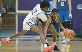  ?? KENNETH K. LAM/STAFF ?? Mount Saint Joseph’s Ryan Truitt, left, knocks the ball away from Loyola Blakefield’s Marlon Williams in the first quarter Monday.