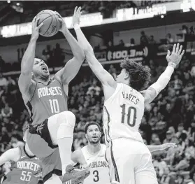  ?? Gerald Herbert / Associated Press ?? Rockets guard Eric Gordon, who started in his first game back from knee surgery, drives for a shot inside on Pelicans center Jaxson Hayes on Sunday.
